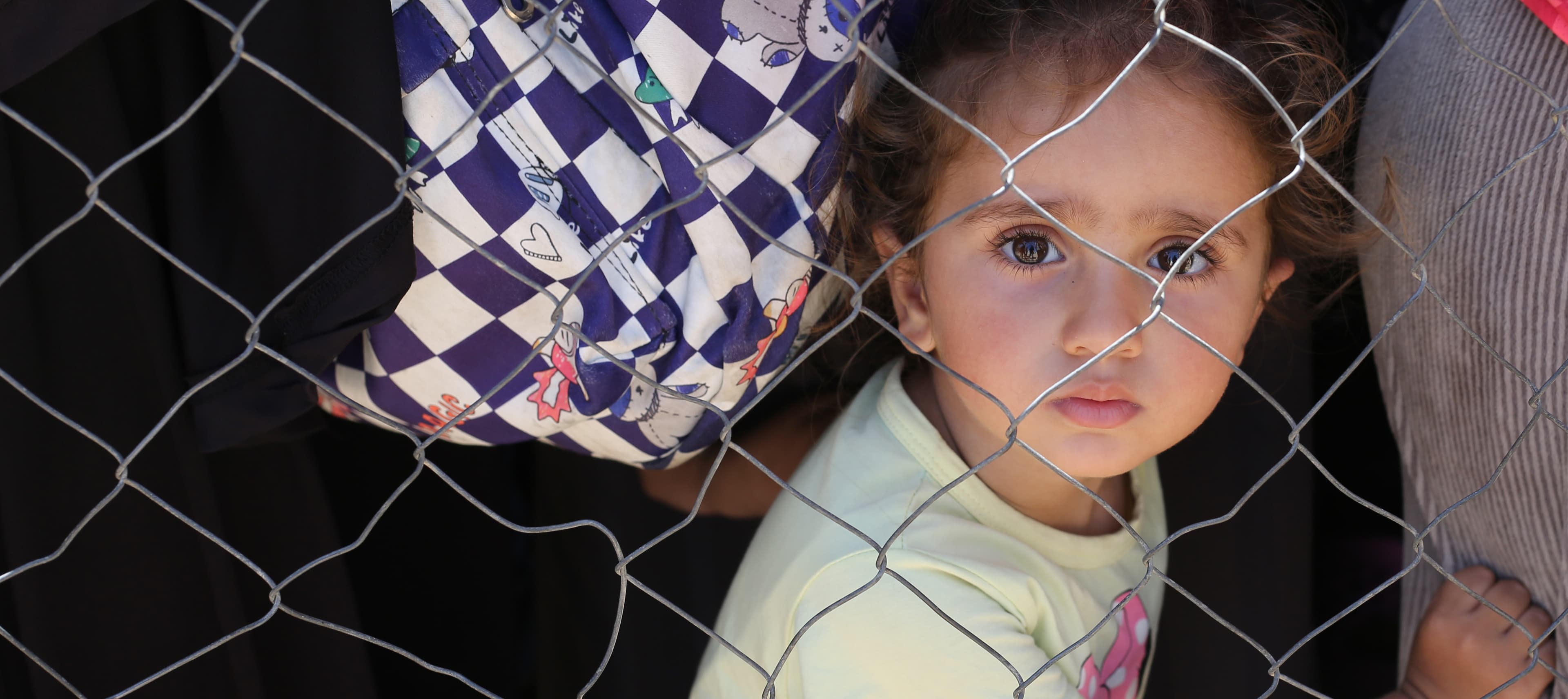 Barn med vuxna - bakom stängsel - Gaza - maj 2025 - desktop cropped